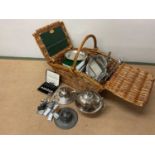 A Fortnum and Mason wicker basket containing silver and plated ware items including a small