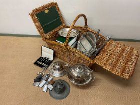 A Fortnum and Mason wicker basket containing silver and plated ware items including a small