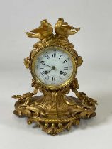 GUICHE; a 19th century French ormolu mantel clock, with twin bird surmount above a white enamel dial