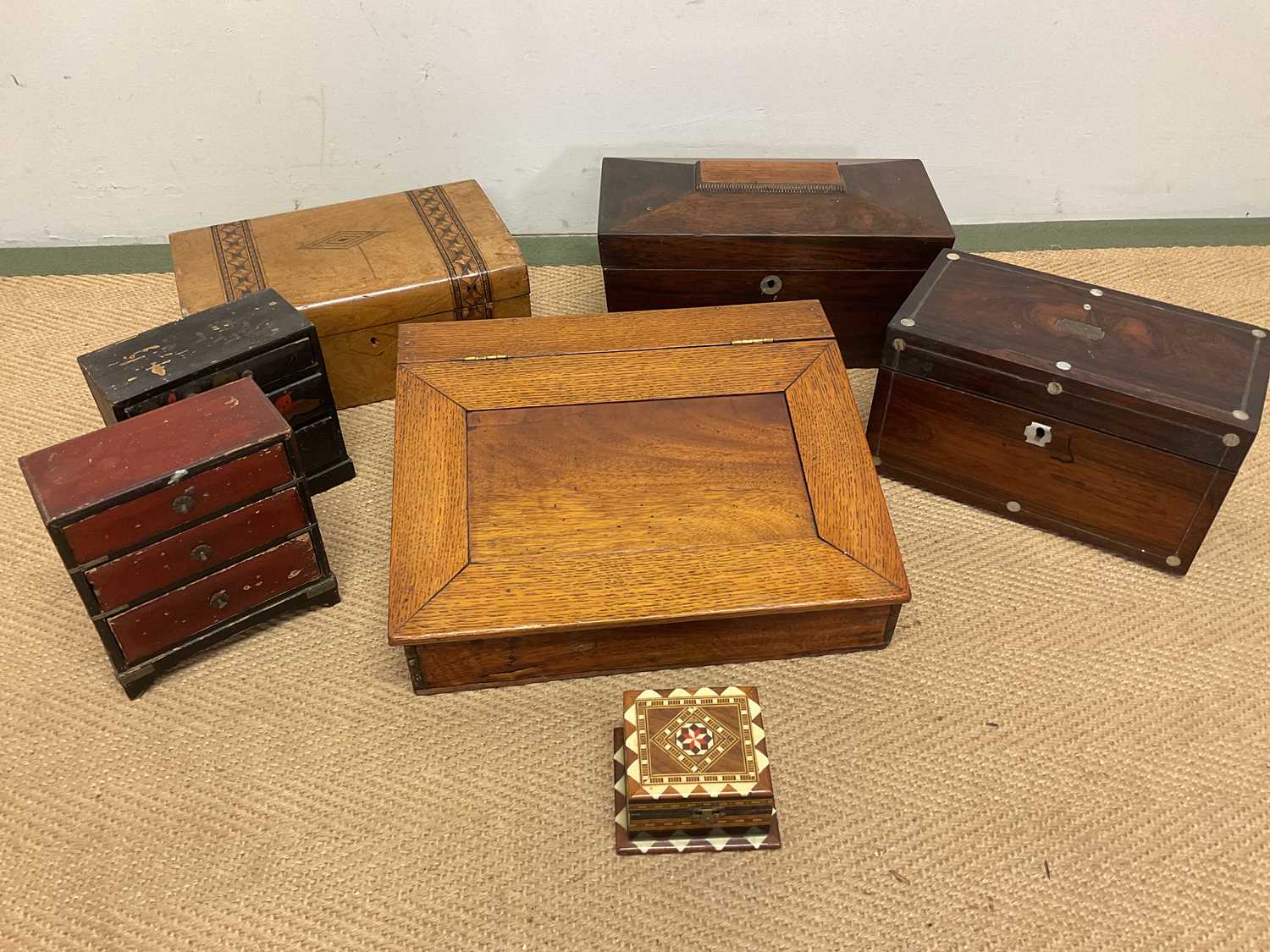 An oak writing slope of small proportions, height 11cm, width 34cm, two tea caddies, an inlaid