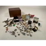 A collection of costume jewellery in a wooden box includes brooches, earrings, watches and others