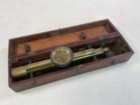 A brass surveyor's level in wooden box