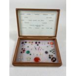 A set of simulated specimen stones used for identifying jewellery, presented in a later cigar box.