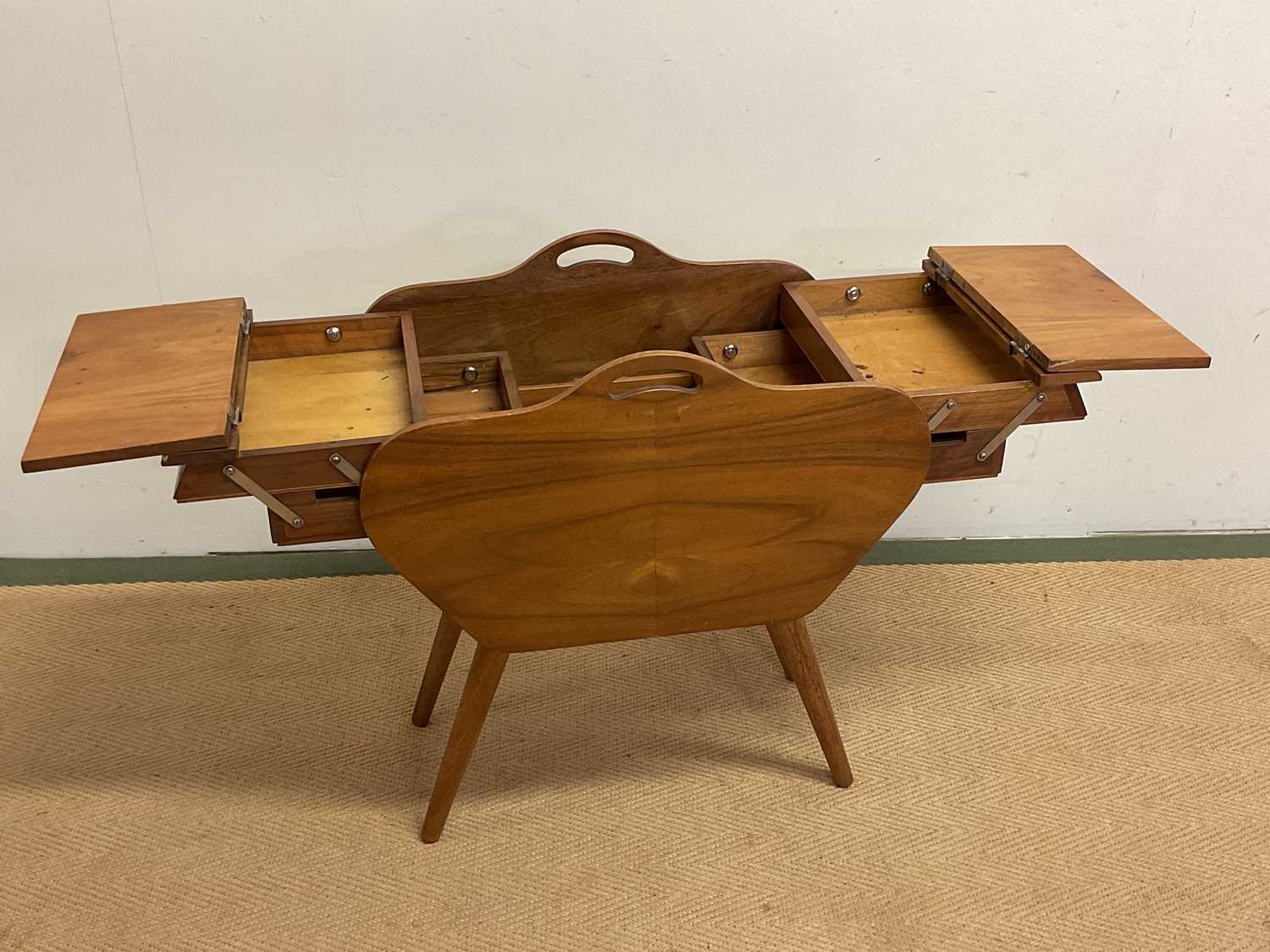A mid century sewing table with fold out drawers, height 56cm, width 50cm, depth 31cm.