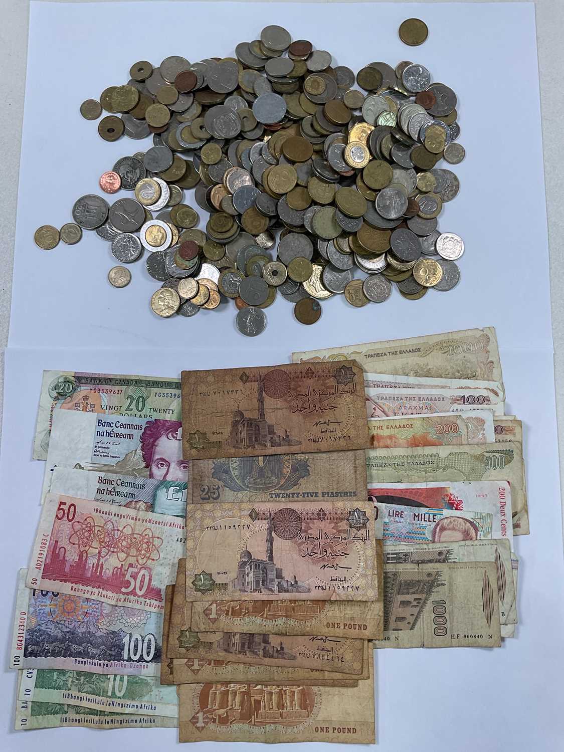 A quantity of world coins and bank notes.