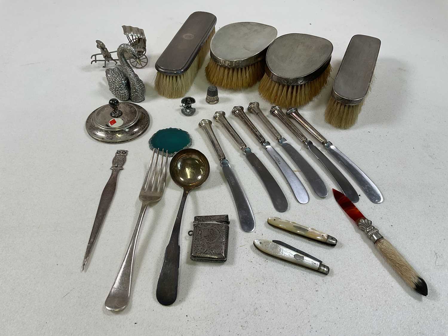 A mixed collection of silver and white metal including a pair of clothes brushes, a pair of hair