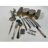 A mixed collection of silver and white metal including a pair of clothes brushes, a pair of hair
