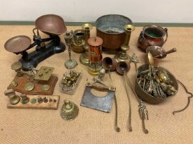 A group of assorted copper and brass to include scales, candlesticks, miner's lamp, mortar and