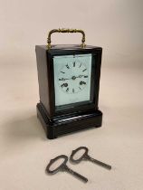 A late 19th century French ebonised and inlaid carriage clock, the swing brass handle showing