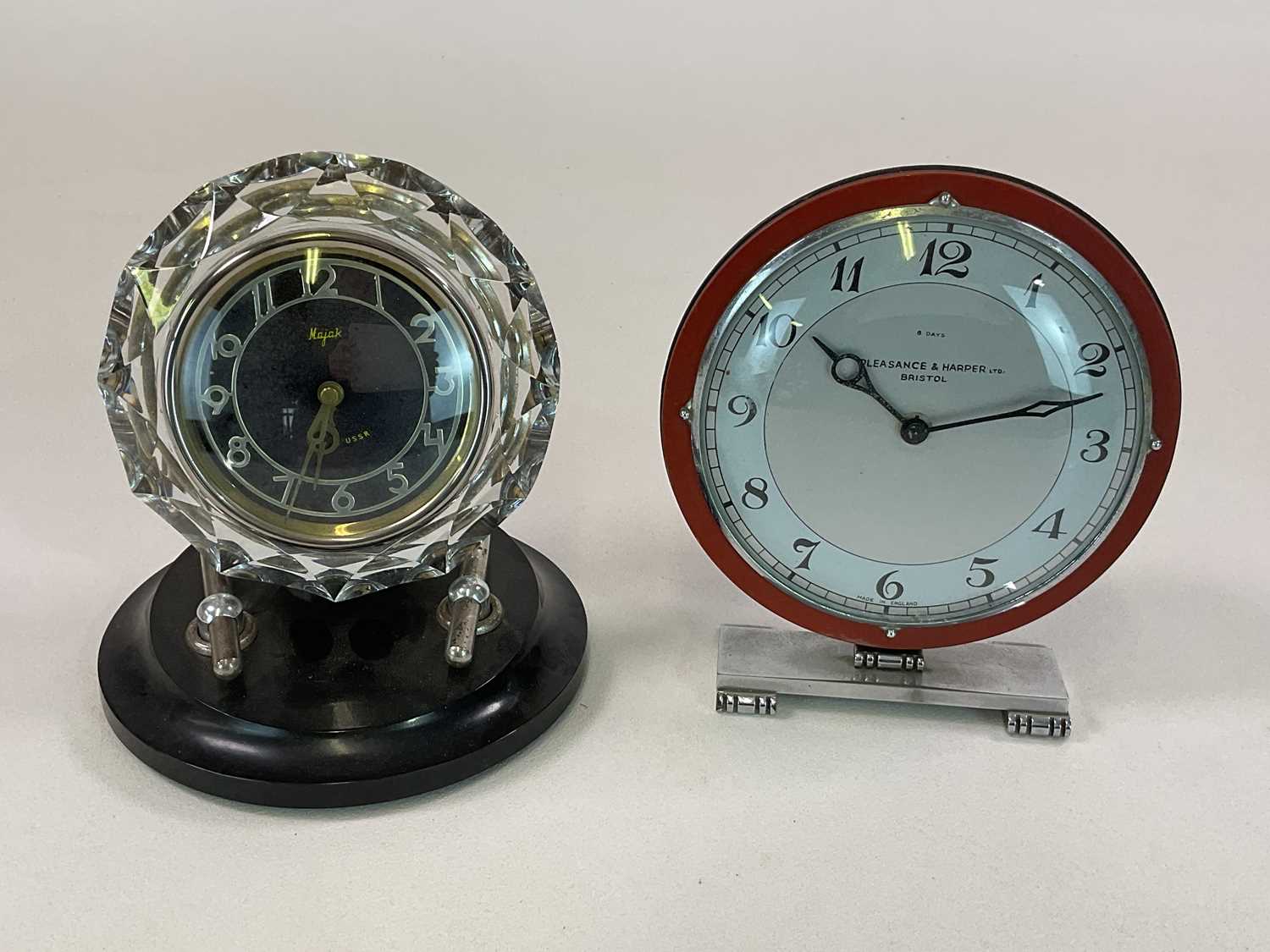 An Art Deco clock by Pleasance & Harper Ltd on chrome base, height 21cm, and a Russian glass clock