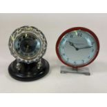 An Art Deco clock by Pleasance & Harper Ltd on chrome base, height 21cm, and a Russian glass clock