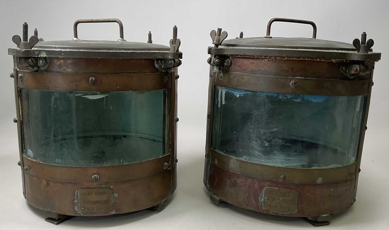A pair of port and starboard ship's lamps, each numbered AP 16199, height 32cm.