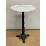 A marble topped table with metal base, height 71cm, width 49cm.
