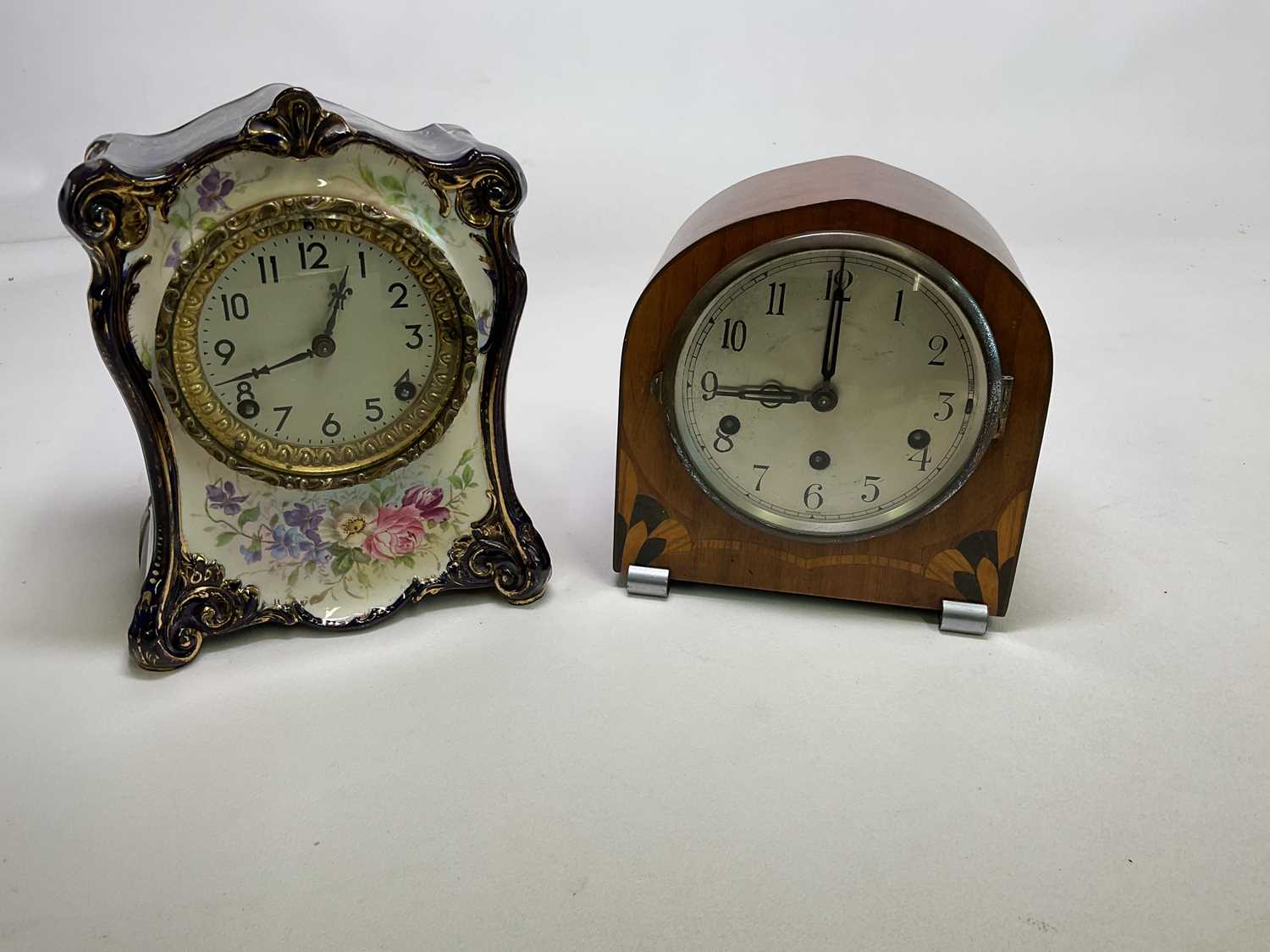 An early 20th century gilt heightened and floral decorated porcelain mantel clock with Arabic