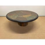 PAUL KINGMA; a circular polished stone table with segmented top, signed within the design, height