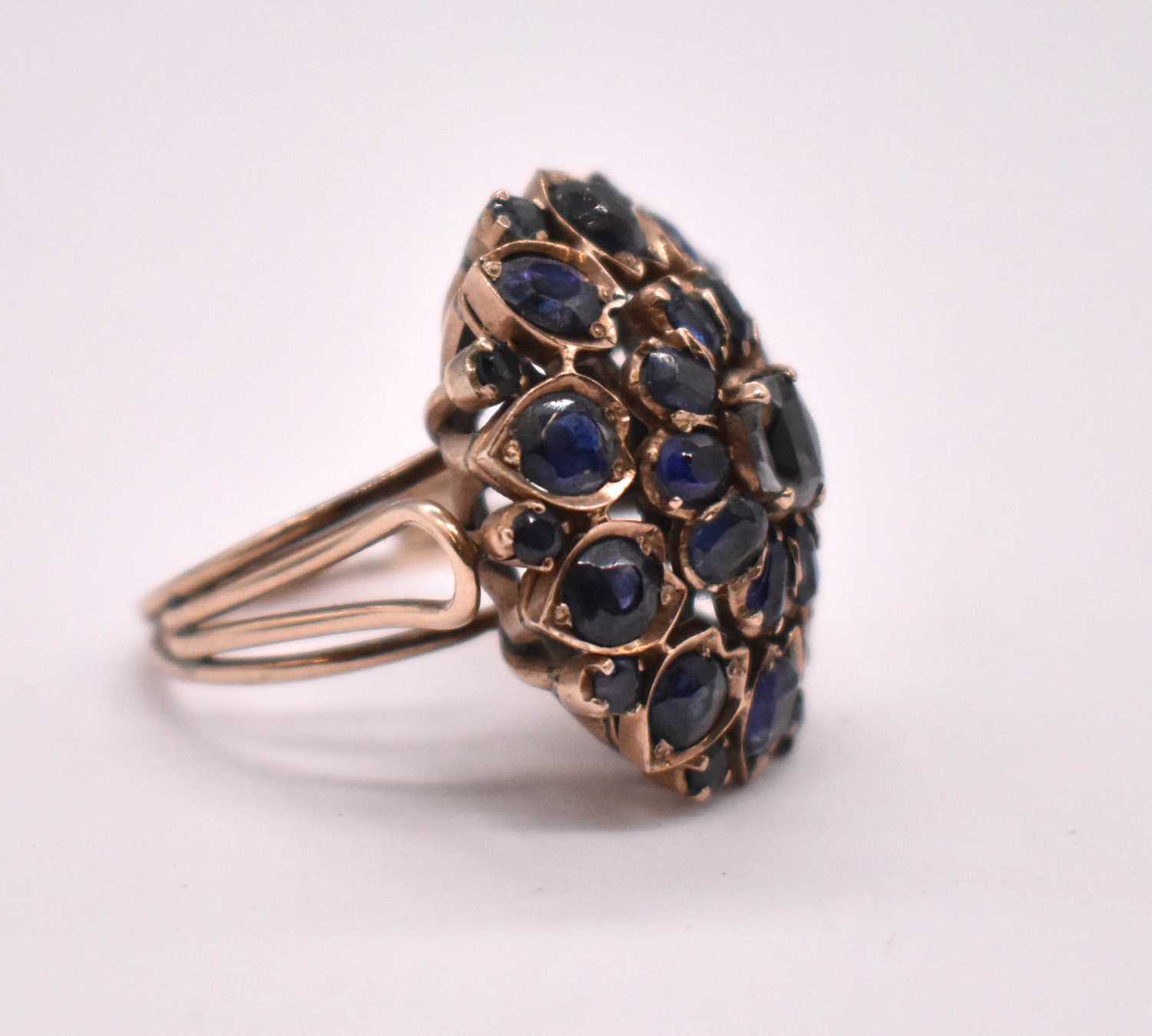 A large yellow metal and sapphire floral cluster ring, size O, approx. 11.16g (three stones - Image 2 of 3