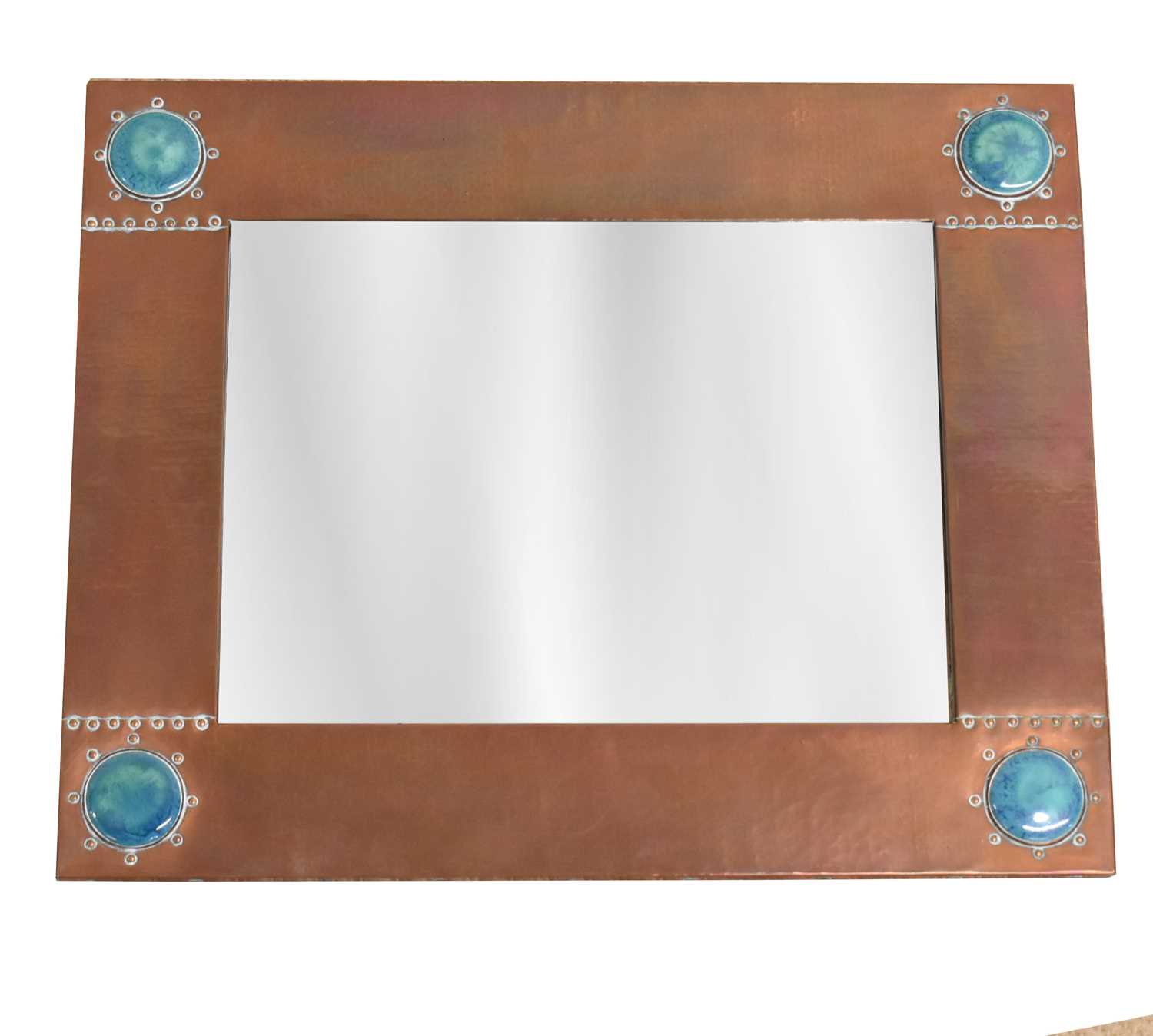 LIBERTY; an Arts and Crafts hammered copper rectangular wall mirror set with four Ruskin type