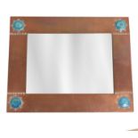 LIBERTY; an Arts and Crafts hammered copper rectangular wall mirror set with four Ruskin type