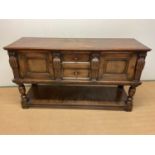 A carved oak sideboard, with two central drawers and two cupboards with lower undertier, height