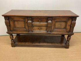 A carved oak sideboard, with two central drawers and two cupboards with lower undertier, height