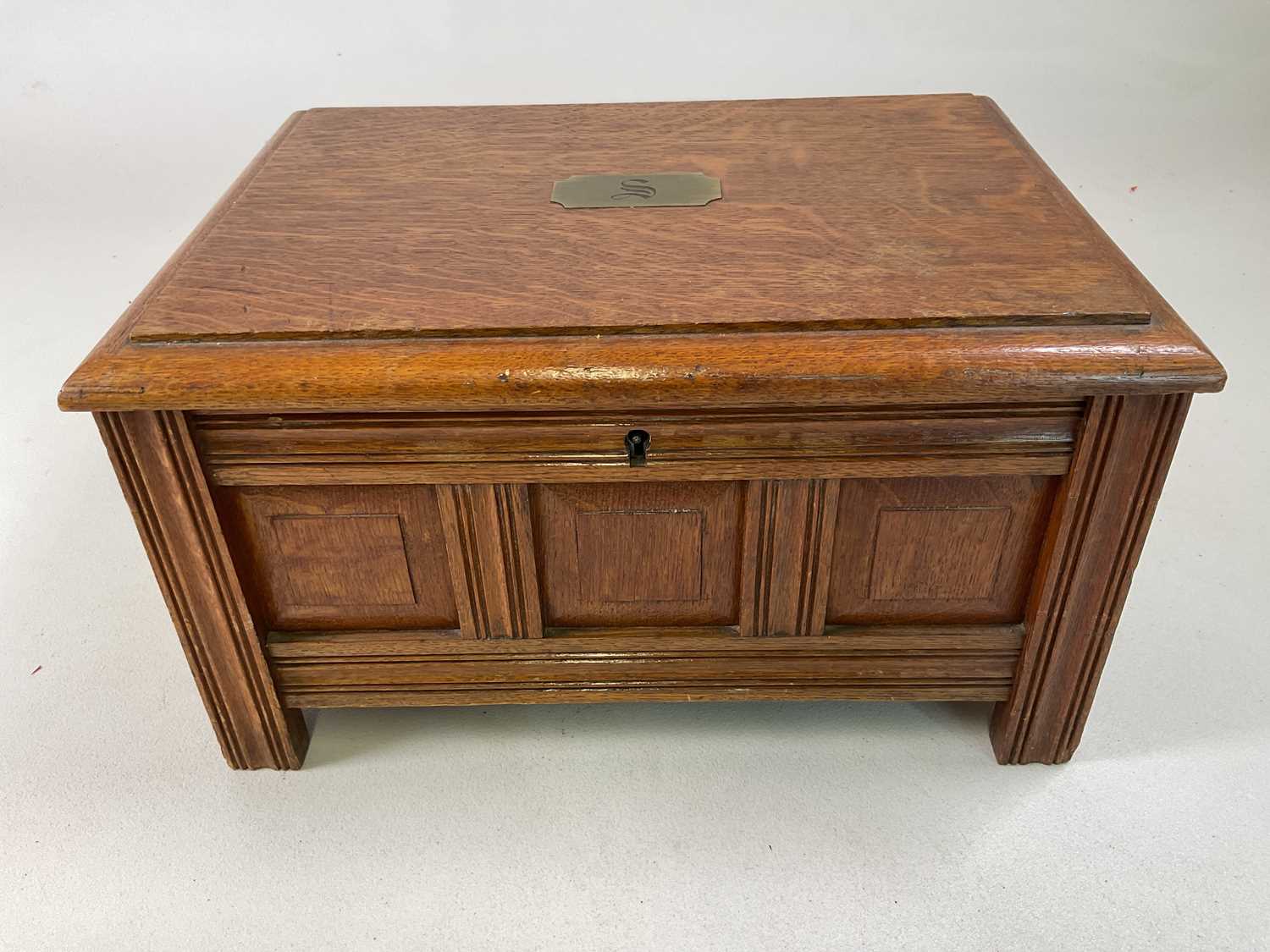 An oak cased canteen of silver plated cutlery, the case unusually modelled as a coffer.