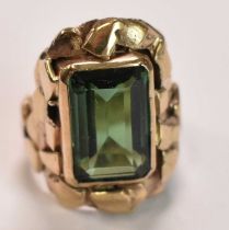 An unusual textured yellow metal ring set with large green stone, size M, approx 10.9g.