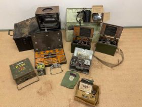 A group of items of military interest including ammo boxes, gas masks, field telephones, morse