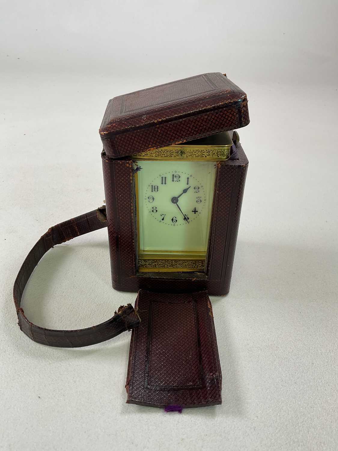 A brass carriage clock with pierced decoration to the case, the enamelled dial set with Arabic - Image 6 of 6