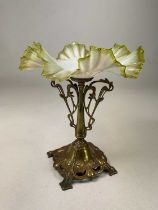 An Art Nouveau centre piece with floral scrolled brass base with opaline and green crimped glass