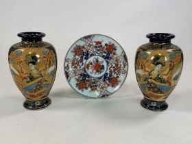 Pair of Japanese Satsuma vases, height 25cm, and an Imari style plate, diameter 24cm.