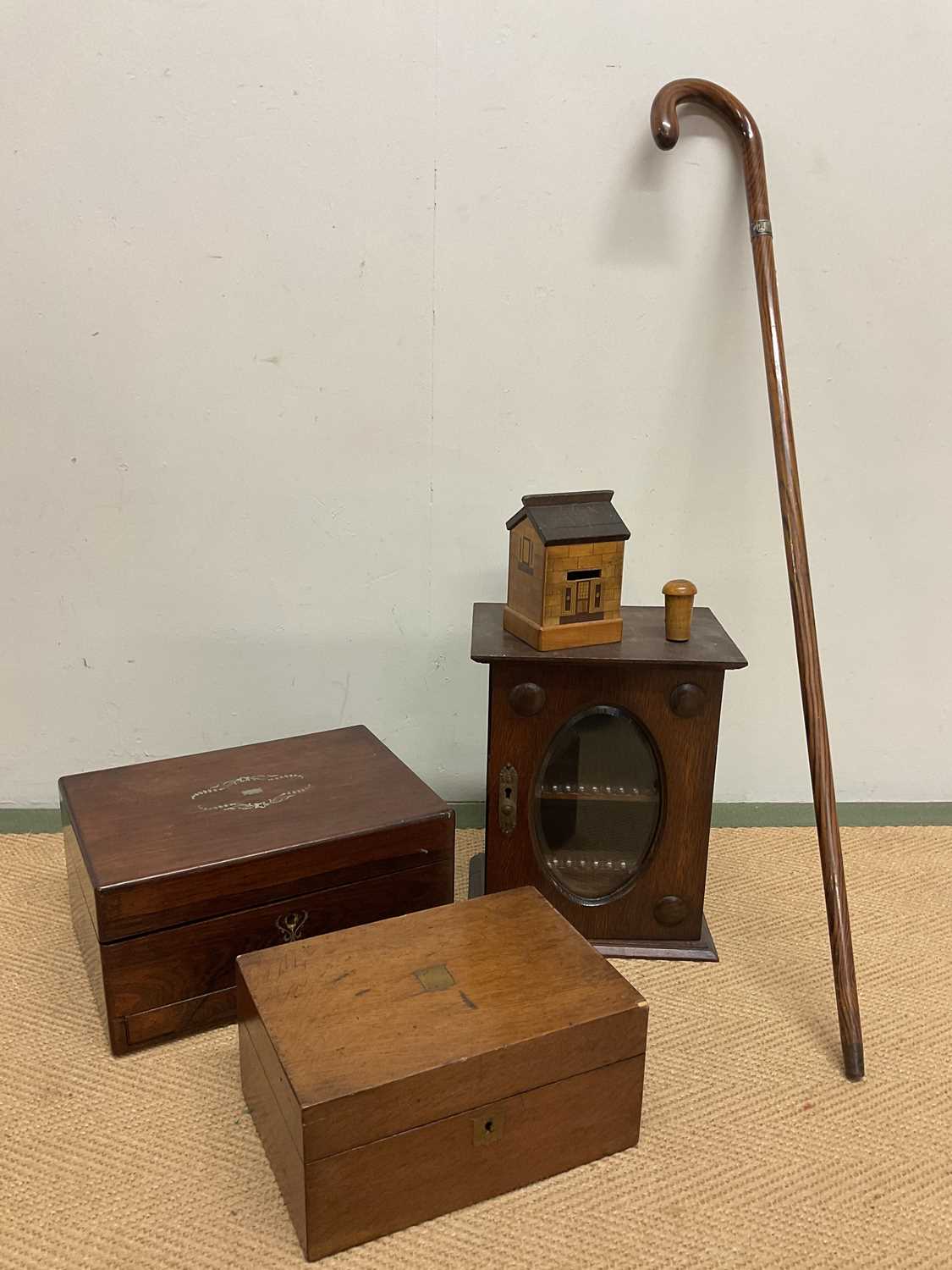 An oak smoker's cabinet with glass drawer to base, a green puzzle money box in the form of a