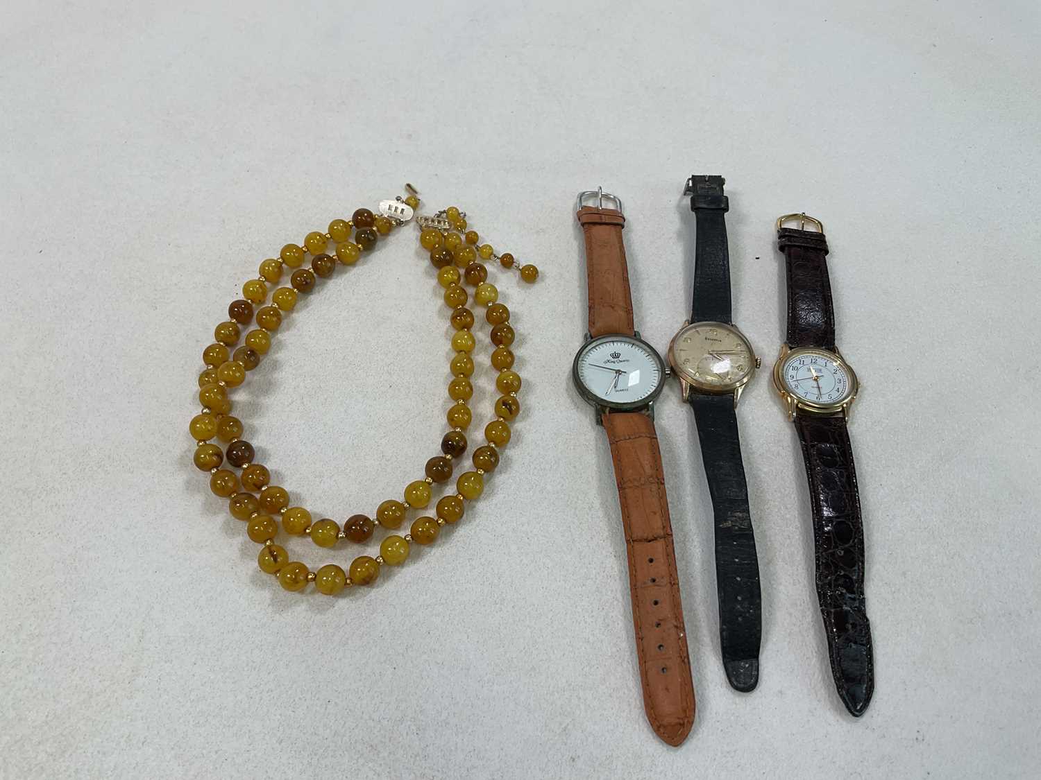 A bead necklace with sphere spacers, a Helvetia vintage wristwatch and a modern wristwatch (3).