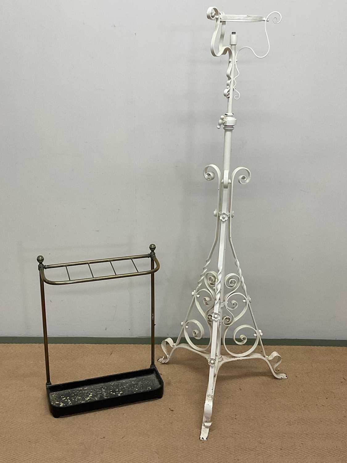 An adjustable painted wrought iron floor lamp, height 134cm in lowest position, and a brass umbrella