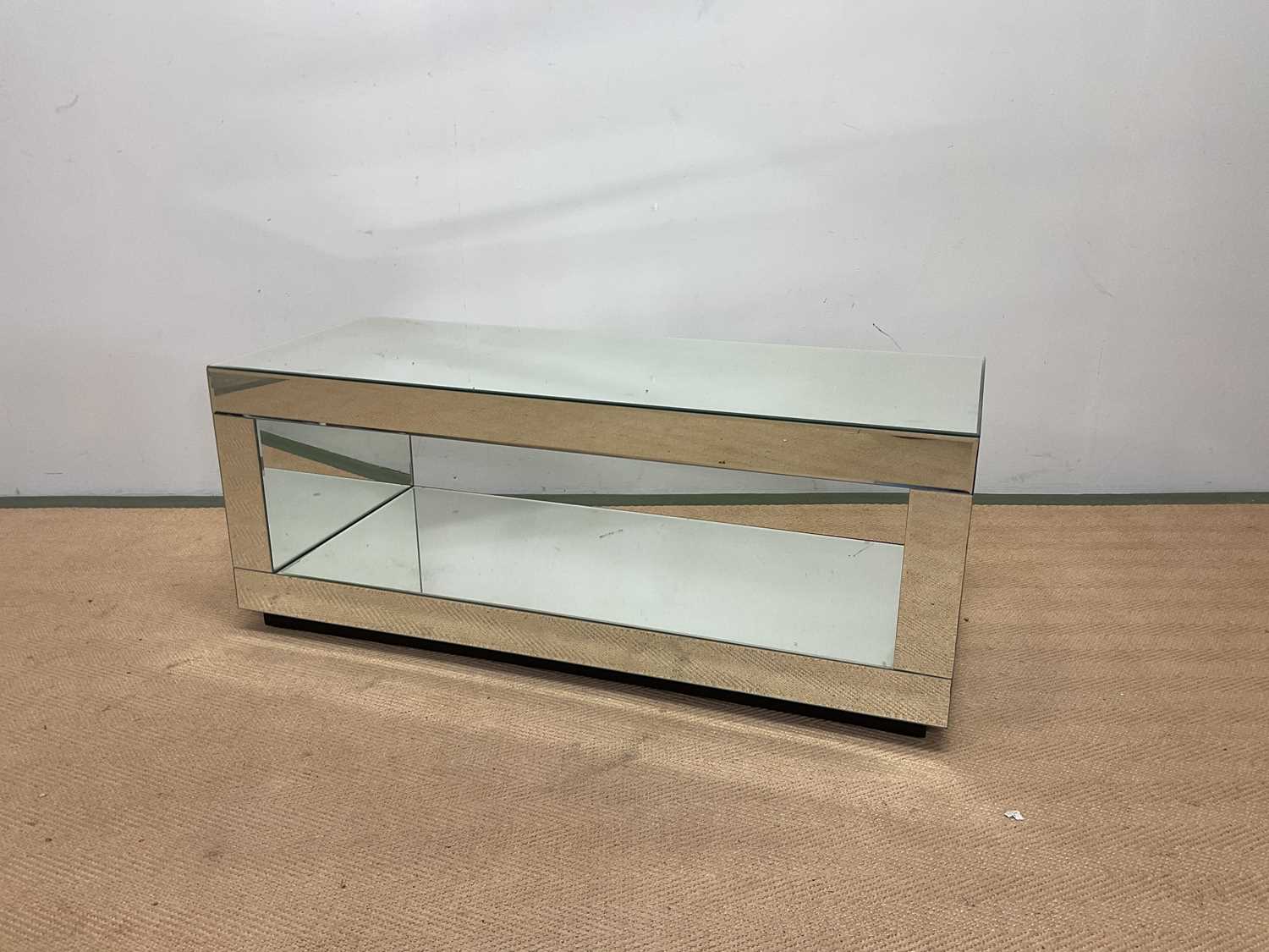A mirrored two tier TV stand, height 40cm, width 100cm, depth 40cm.