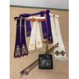 A collectors' lot comprising a quantity of embroidered vestments (af), three violin bows, a crucifix