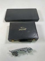 A Jaguar car mascot with a Jaguar cased tool kit and a Jaguar branded games compendium Condition