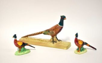 BESWICK; a model of a pheasant on rectangular base, no. 1774 and two smaller pheasants on