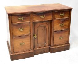 An early 20th century mahogany side cabinet with central frieze drawer above arched panelled door