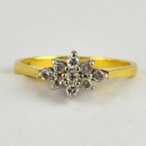 An 18ct gold diamond cluster ring, the trapezium shaped top with tiny diamond cluster, size N,