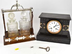 A 19th century black slate mantel clock, the circular white enamelled dial set with Roman