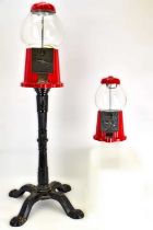 Two vintage gumball dispensers, the largest by Carousel on replica cast iron style stand to four