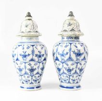 A pair of early 19th century Dutch tin glazed baluster vases decorated with bands of stylised