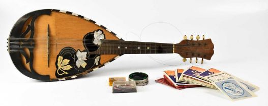 A domed backed rosewood mandolin with inlaid mother of pearl Art Nouveau floral decoration, together