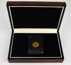 A George V half sovereign 1911, in Perspex slab, wooden presentation case and cardboard box.