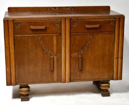 A c.1930s oak sideboard with two drawers over two cupboard doors, 87 x 120 x 46cm.