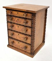 An Oregon pine collectors' cabinet of five graduated drawers, 90 x 40 x 33cm.