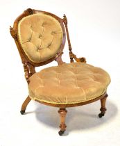 An Edwardian inlaid walnut chair with button back beige velvet upholstery, on castors, height 70cm.