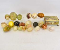 Approximately twenty-one onyx, polished marble and wooden eggs, and an onyx casket (22).