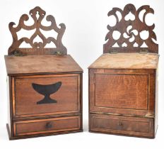 Two late 18th/early 19th century oak wall-mounted salt boxes, both with open fretwork top, inlaid