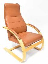 A modern brown leather easy chair with beech finish. Condition Report: With fire labels
